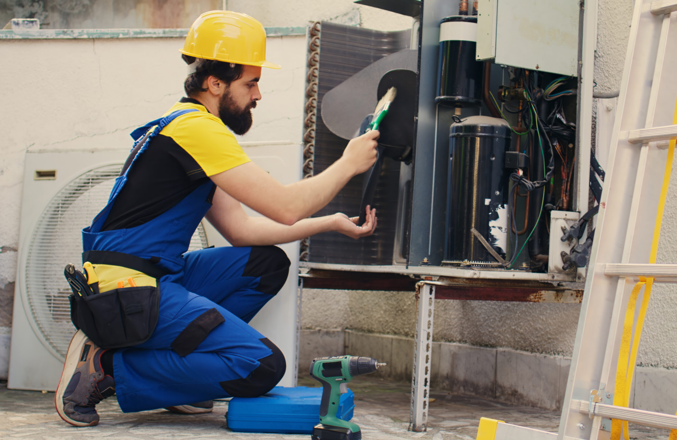 Proficient expert commissioned by client to fix out of order air conditioner using soft dusting brush to remove built up layer of dirt and dust that is slowing down internal parts